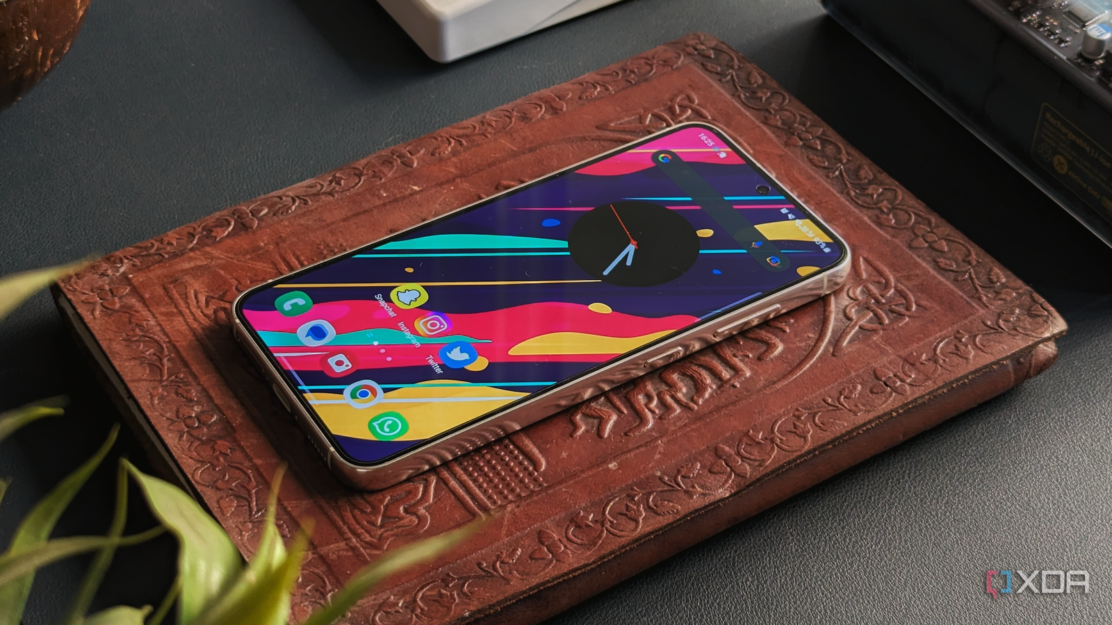 Samsung Galaxy S23 lying on a book with the display on.