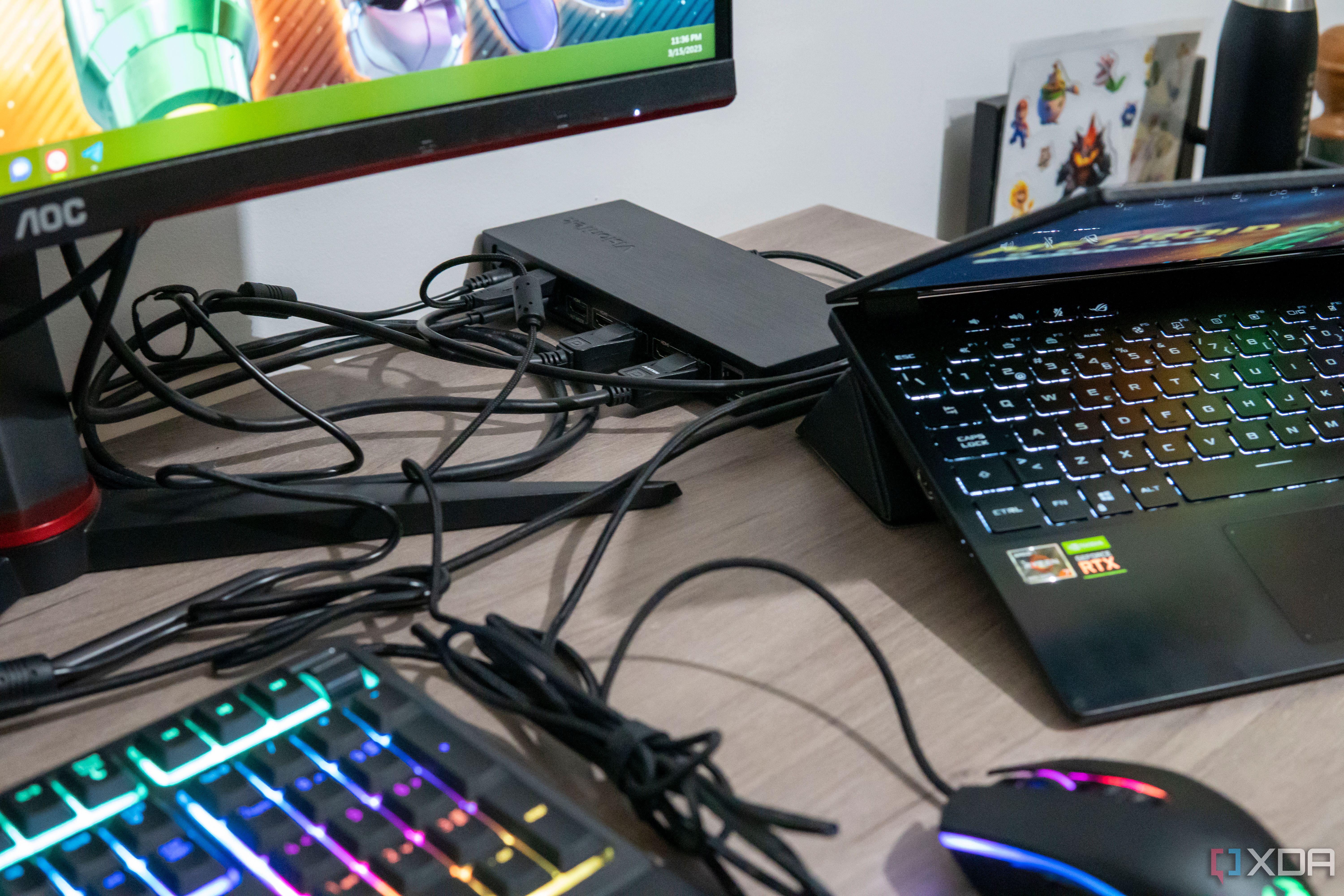 A VisionTek VT7400 docking station with a laptop and multiple peripherals around it