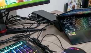 A VisionTek VT7400 docking station with a laptop and multiple peripherals around it