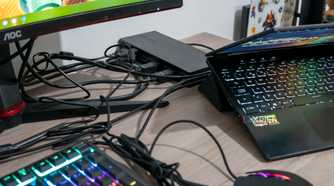 A VisionTek VT7400 docking station with a laptop and multiple peripherals around it
