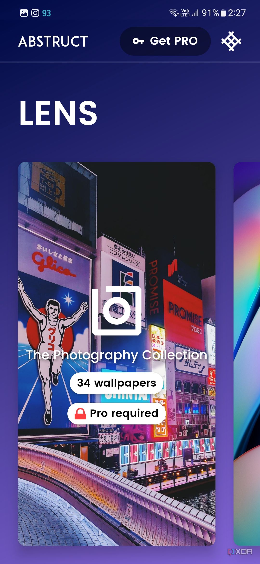 A screenshot showing the cover image of 'Lens' collection of abstract wallpapers within the Abstruct app.