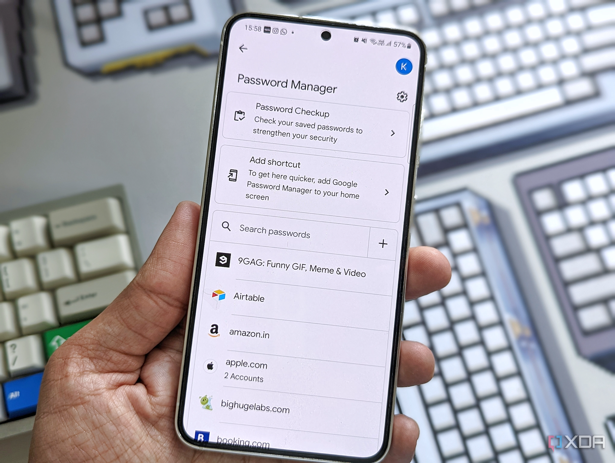 A person holding a Galaxy S23 with Google's Password Manager page open on its display.