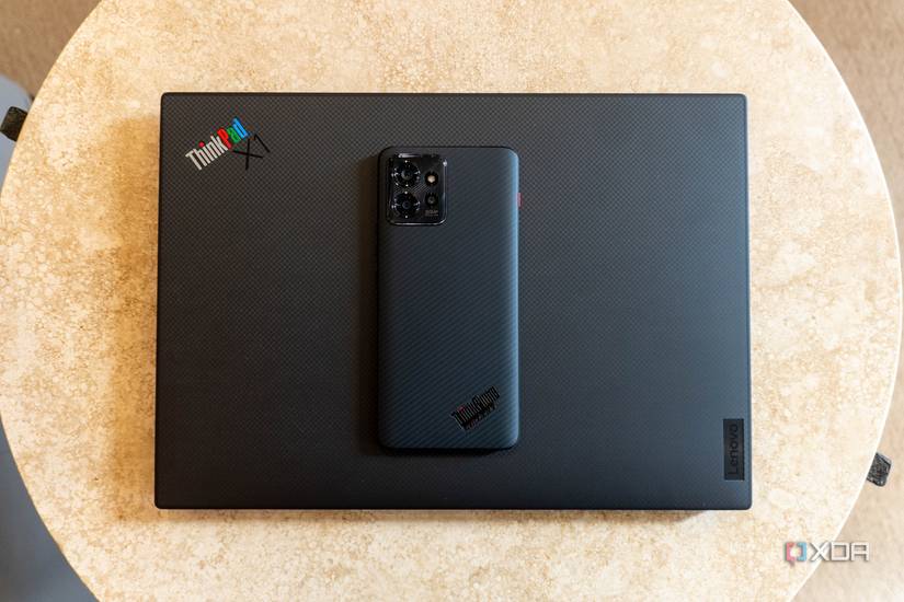 ThinkPhone on top of a ThinkPad laptop