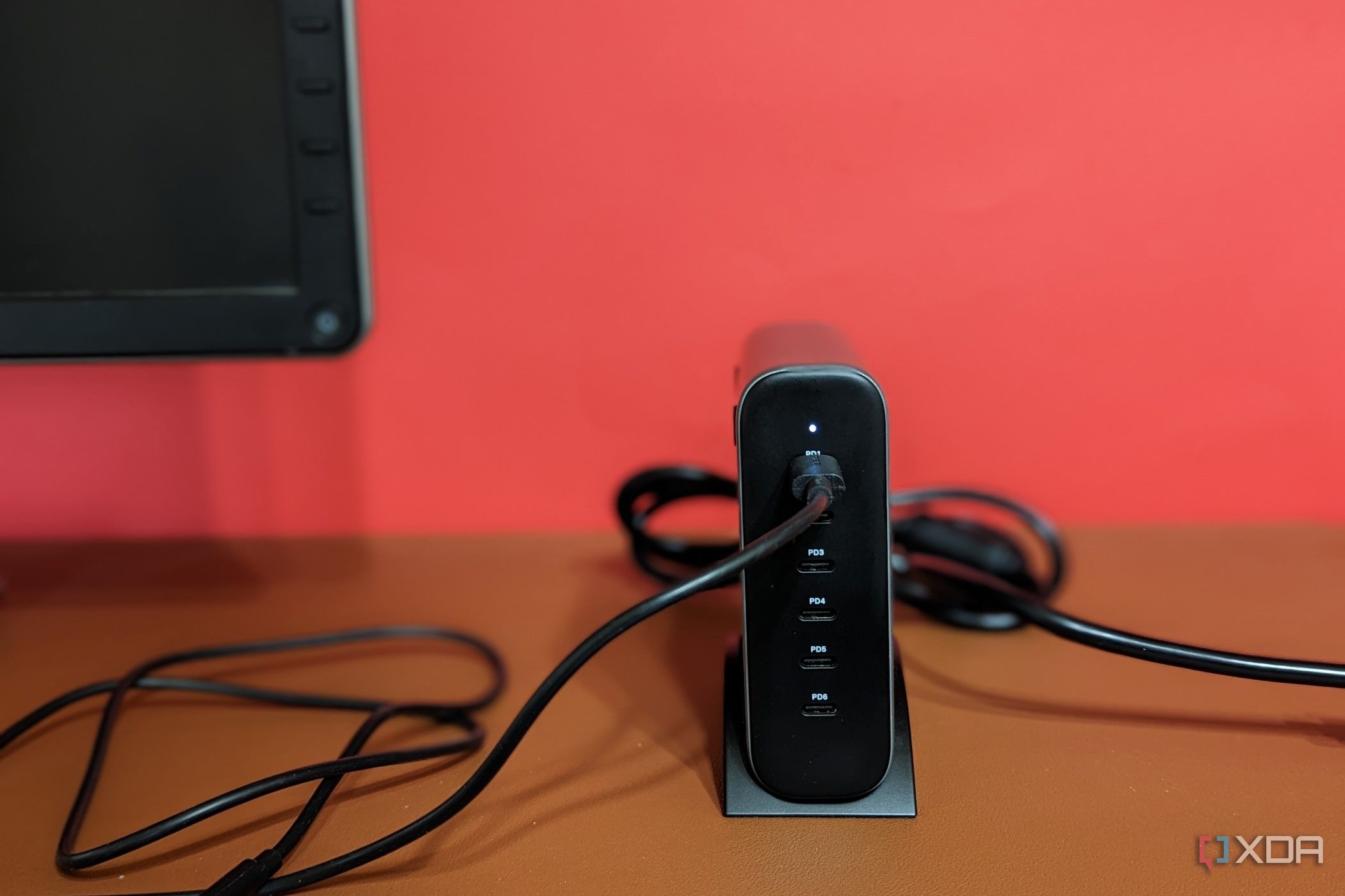 Satechi GaN 200W USB C Charger tucked next to a monitor