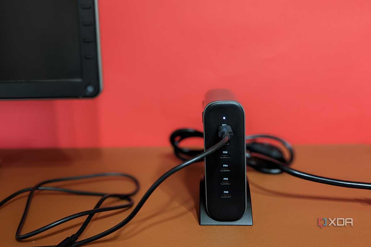 Satechi GaN 200W USB C Charger tucked next to a monitor