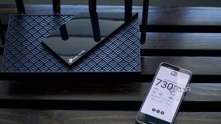 TP-Link Archer AXE75 router with speed test of an Archer AXE300
