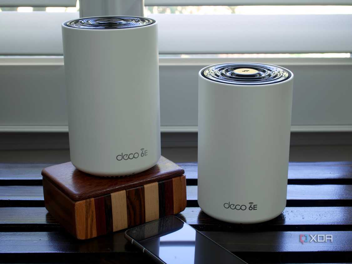 TP-Link Deco XE75 nodes on a wooden box