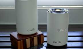 TP-Link Deco XE75 nodes on a wooden box