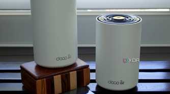 TP-Link Deco XE75 nodes on a wooden box