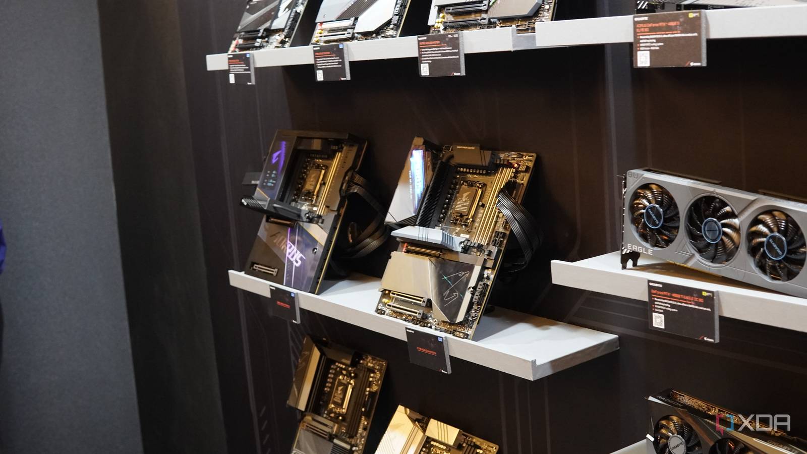 Multiple Gigabyte motherboards and GPUs on shelves