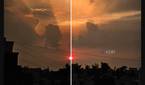 A screenshot showing a slider in the middle of a sunset image being edited in Galaxy Enhance-X app.