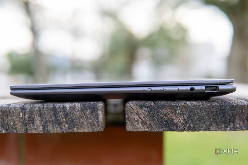 Right side view of the Lenovo Slim Pro 7 showing an USB Type-A port, headphone jack, power button, and electronic kill switch for the webcam