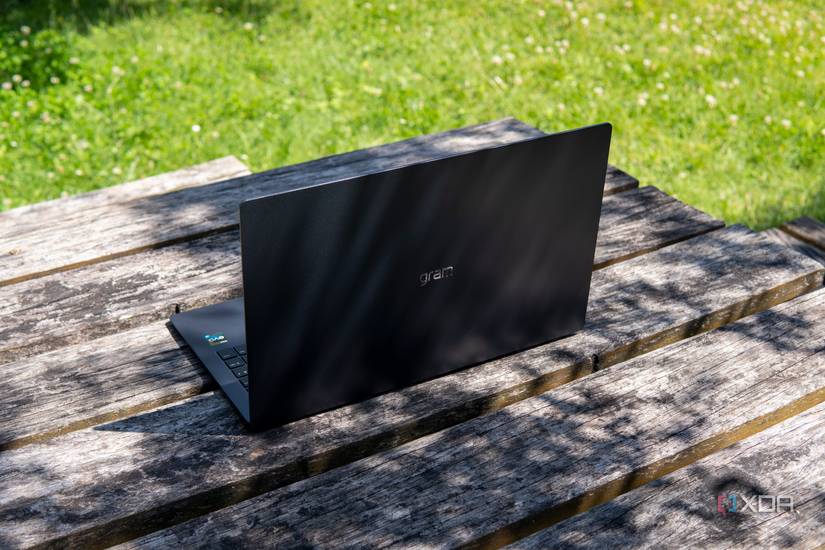 Angled rear view of the LG Gram SuperSlim on a wooden table with a shadow partially covering it