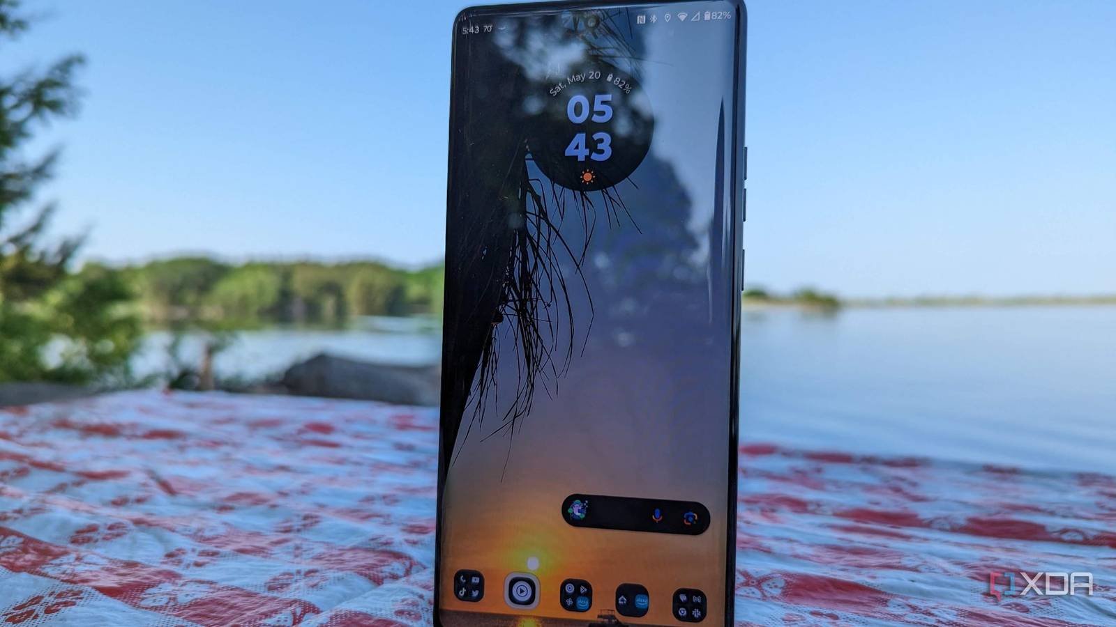 Motorola Edge+ 2023 on a table in front of a lake