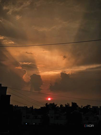 An image showing a sunset with its lights shining through the clouds.