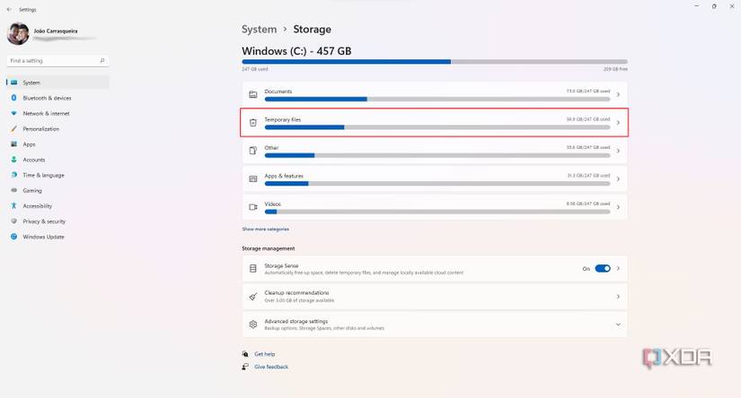 Screenshot of Windows 11 Storage settings. The temporary files button is highlighted with a red outline