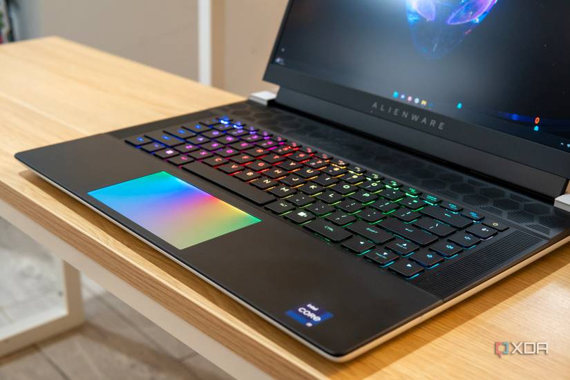 Angled view of the base of the Alienware x16 showing RGB lighting on the keyboard and touchpad.