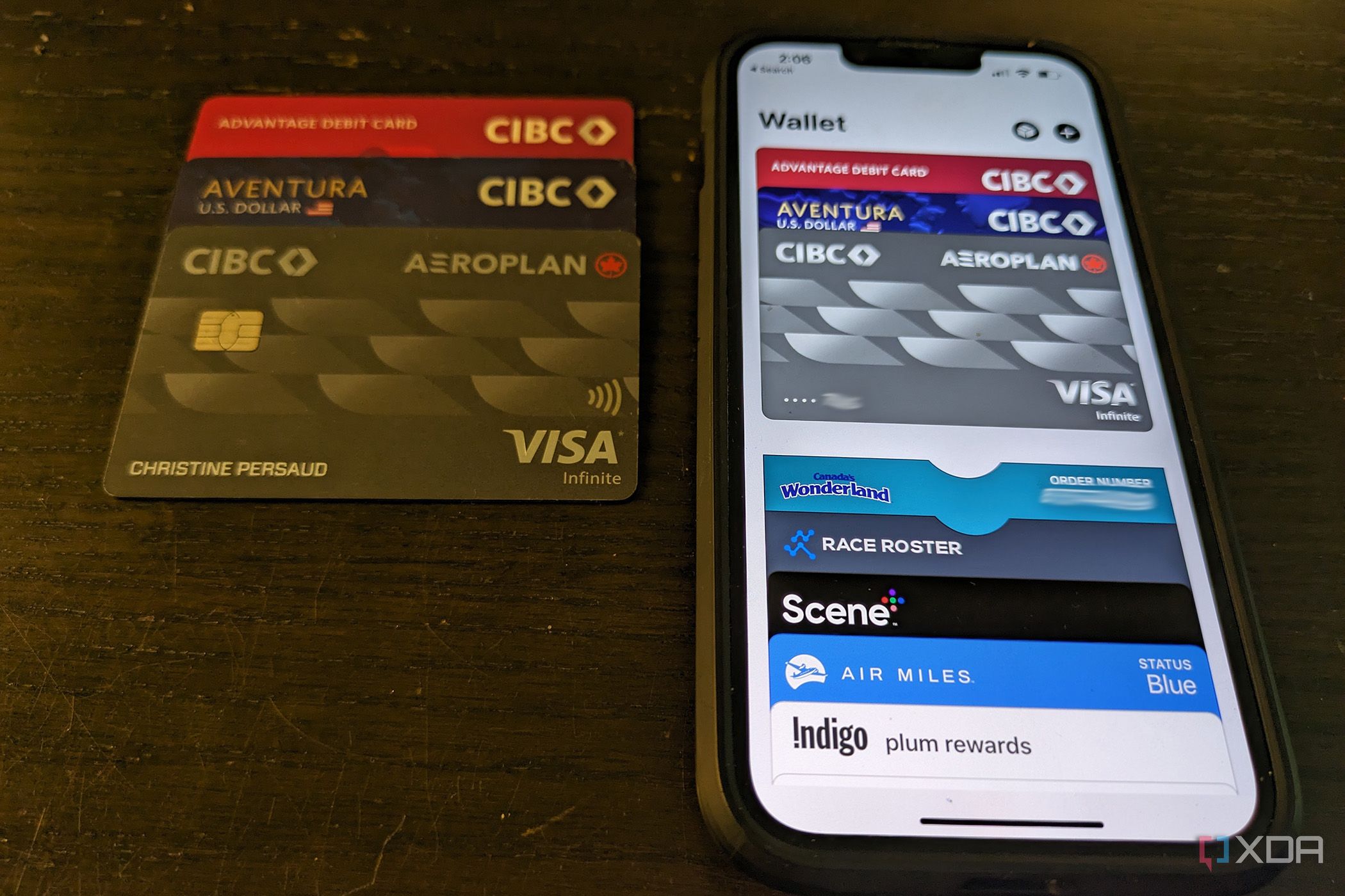Apple wallet on iPhone next to physical bank cards
