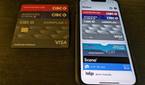 Apple wallet on iPhone next to physical bank cards