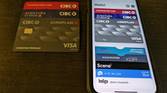 Apple wallet on iPhone next to physical bank cards