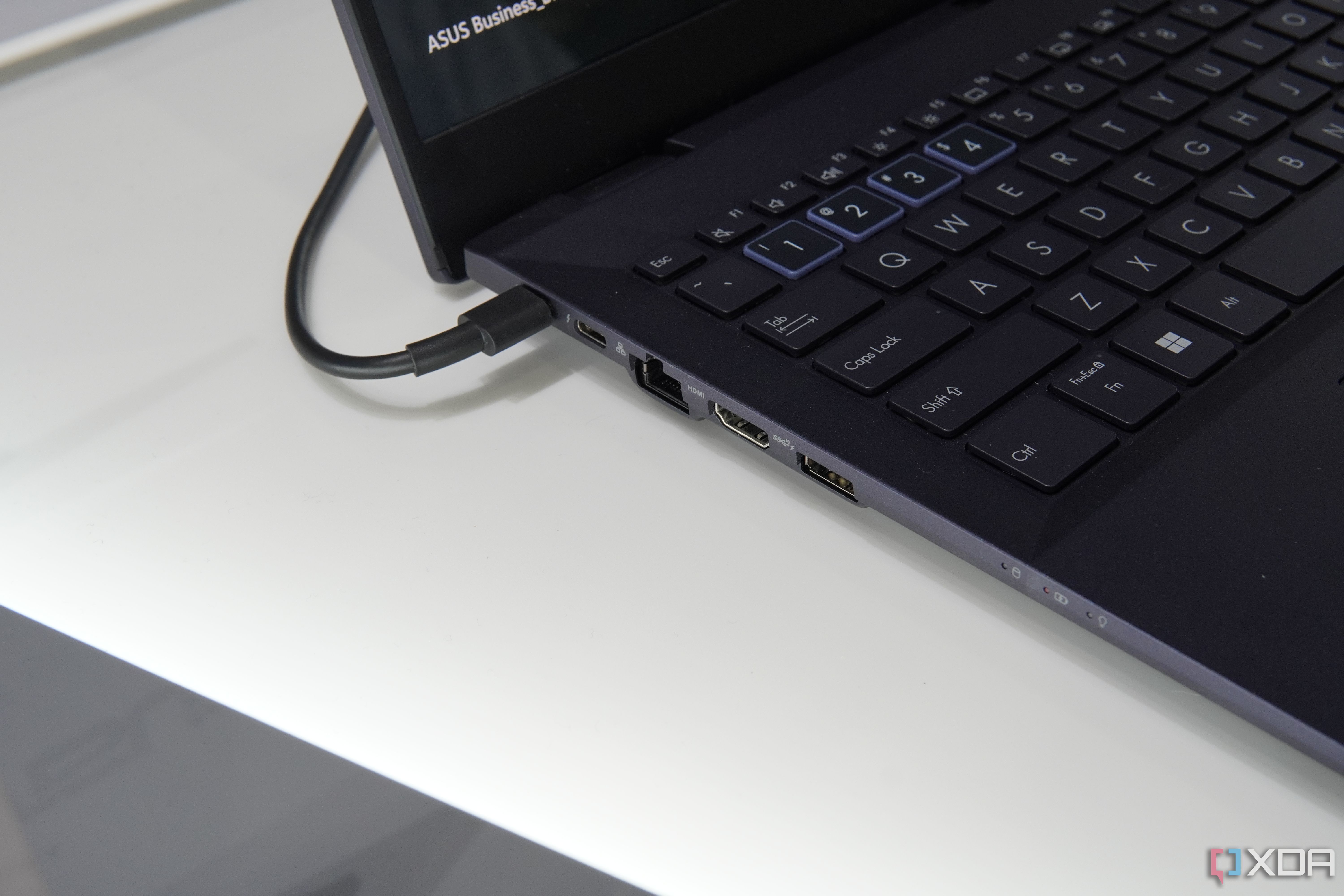 Close-up view of the ports on the left side of the Asus ExpertBook B5 OLED, including USB Type-A, HDMI, Thunderbolt 4, and RJ45 Ethernet
