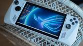 Asus ROG Ally on a bookshelf showing the Windows 11 desktop.