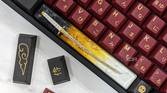 An image of a mechanical keyboard with GMK Red Samurai keycaps kept on a white marble.