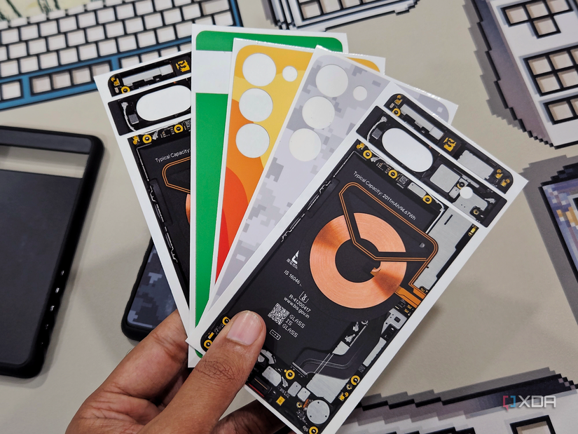 An image of a person holding Dbrand skins for the Grip case.