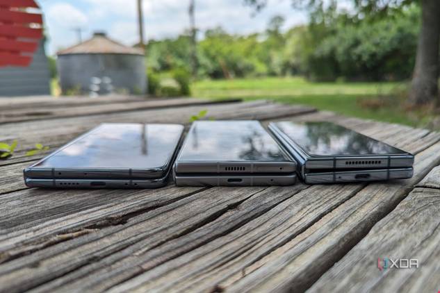 Google Pixel Fold, Tecno Phantom V Fold, and Samsung Galaxy Z Fold 4 lying flat on a table.