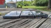 Google Pixel Fold, Tecno Phantom V Fold, and Samsung Galaxy Z Fold 4 lying flat on a table.