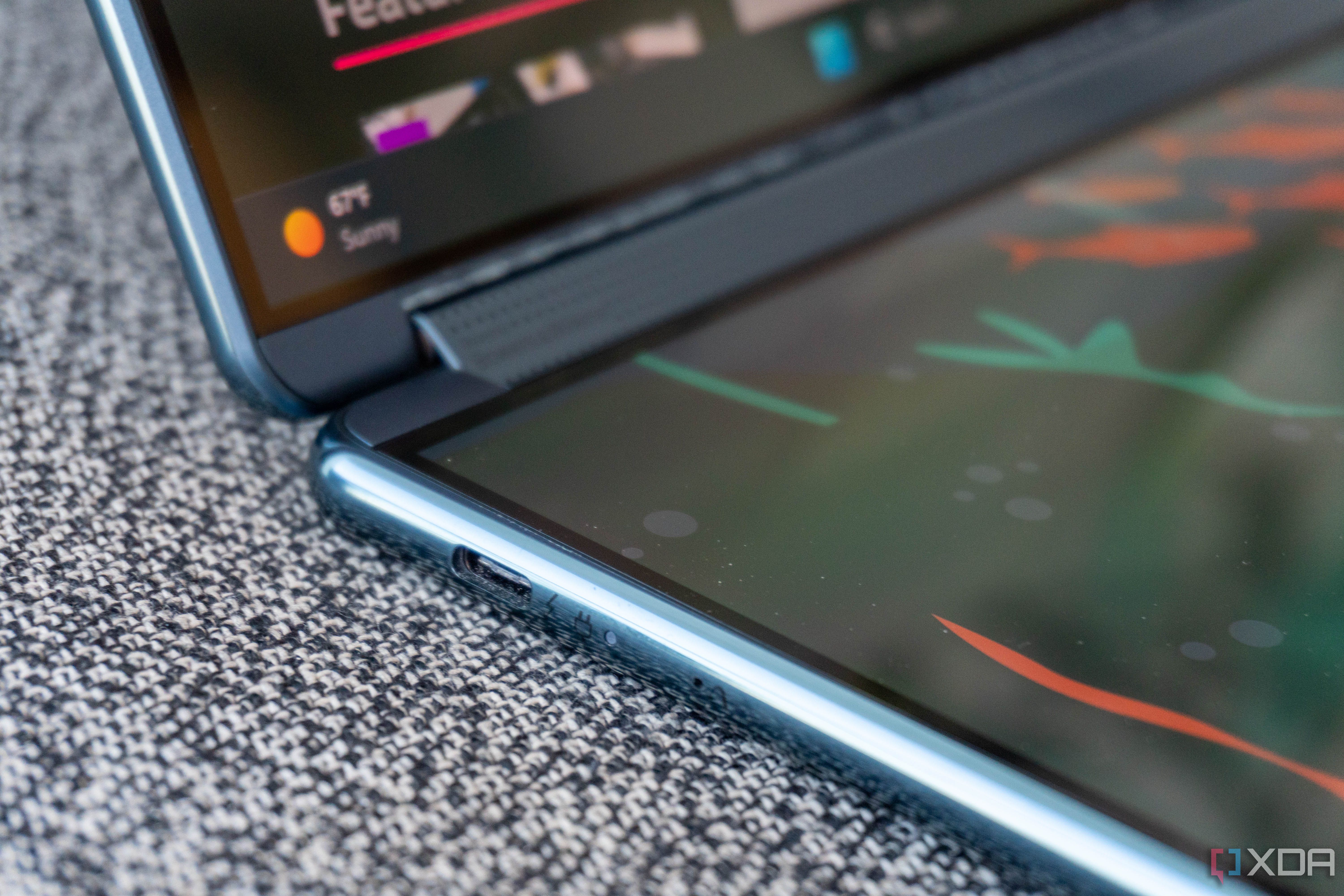 The speaker grill hidden in the Yoga Book 9i's hinge. 