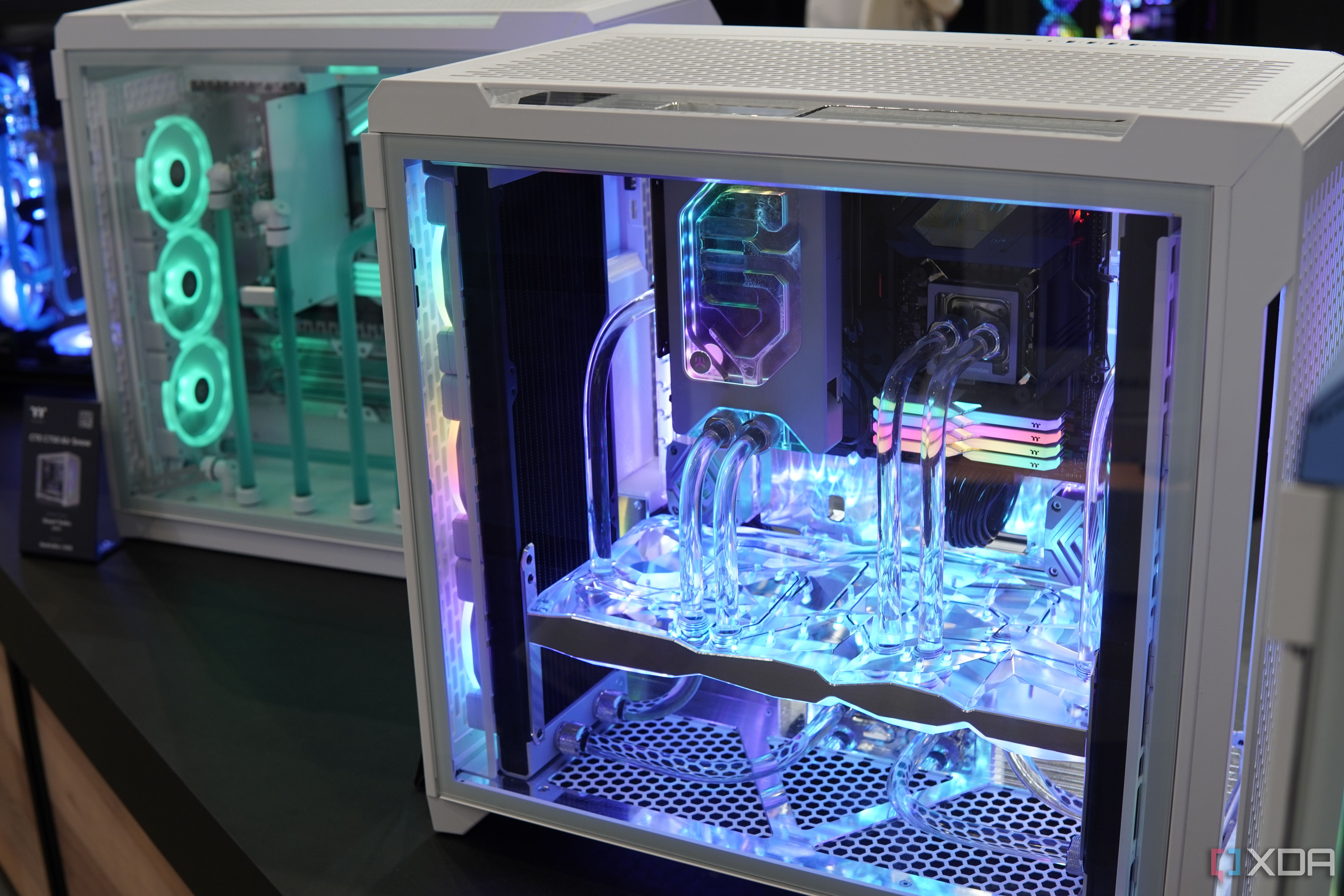 A custom PC built inside a Thermaltake case featuring multiple transparent components and RGB lighting