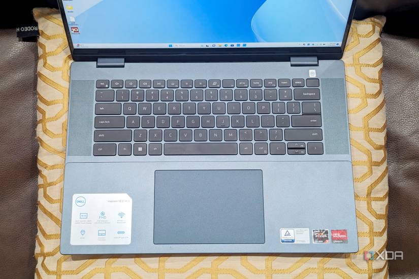 Dell Inspiron 16 on a pillow showing the keyboard