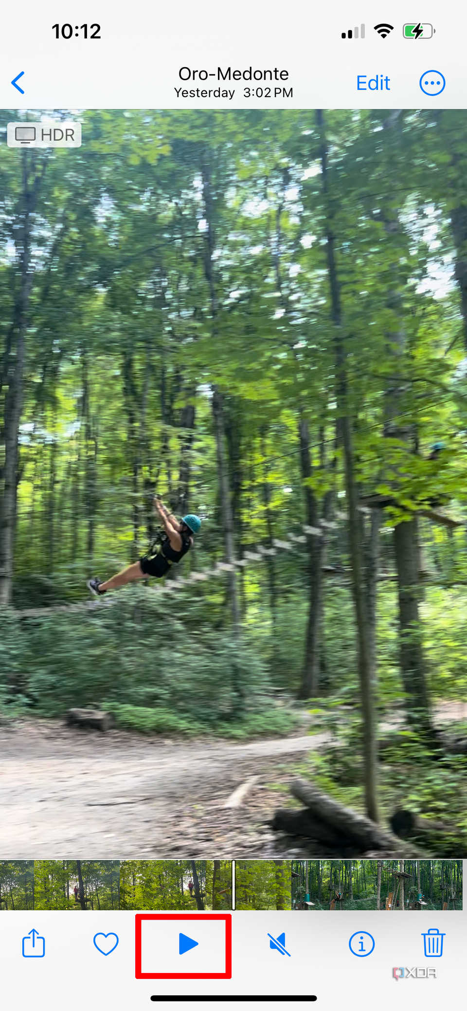 A video of a woman ziplining playing on an iPhone, paused.