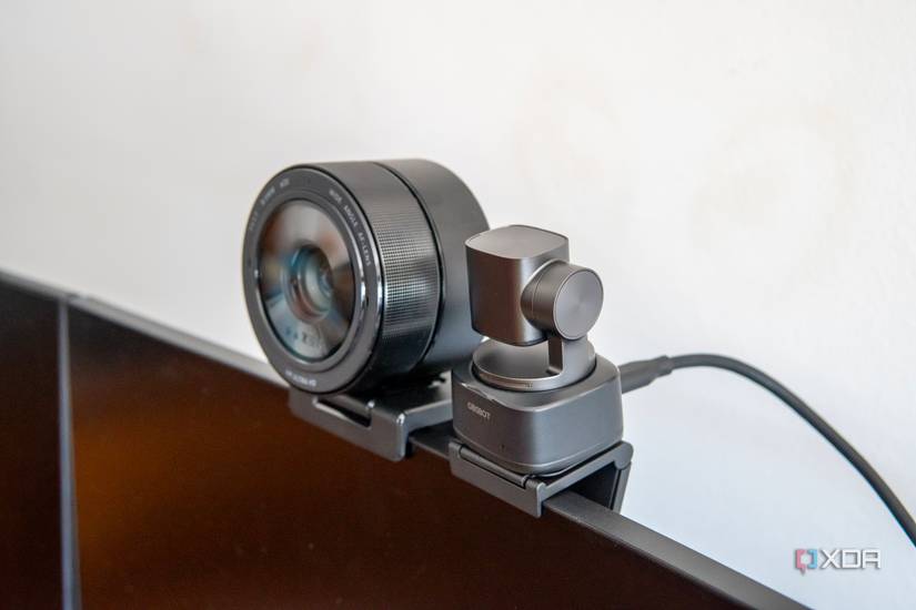 Angled view of the Obsbot Tiny 2 webcam next to the Razer Kiyo Pro Ultra, showing that the latter is signficiantly wide and deeper.