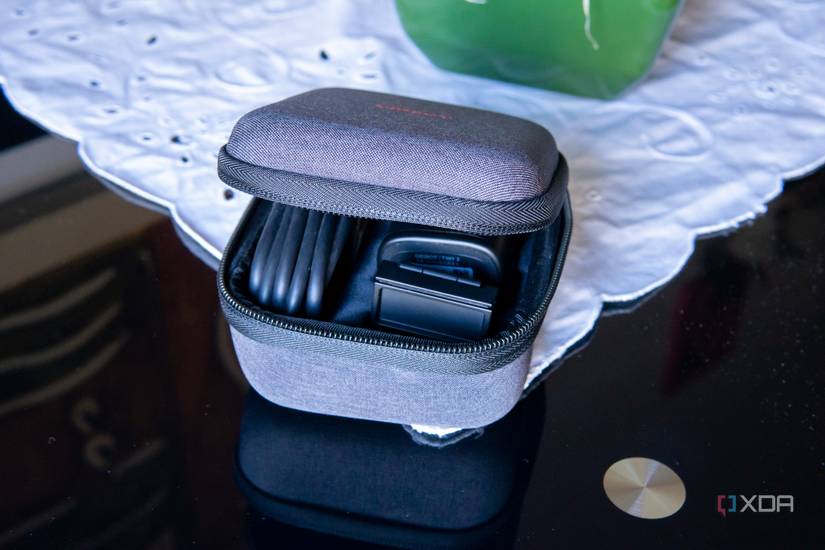 A cartrying case included with the Obsbot Tiny 2 webcam, housing the webcam, monitor mound, and USB cable. The case has a hard shell.