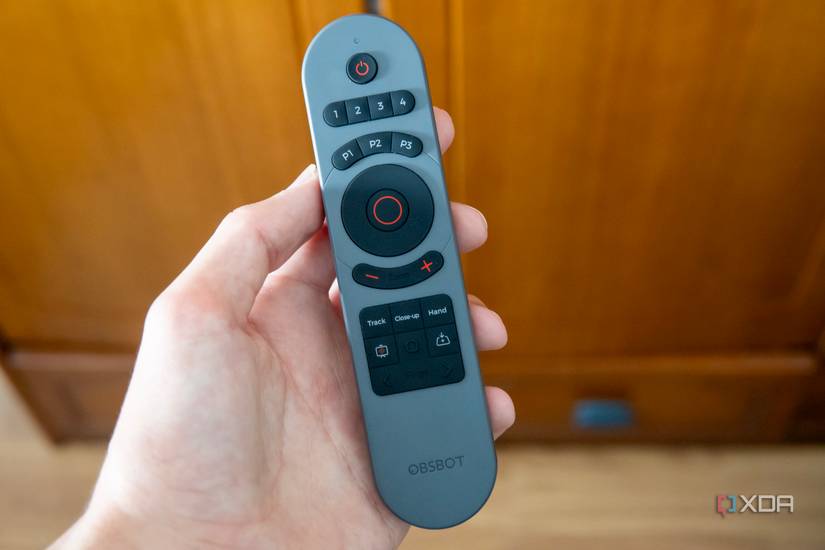 A remote control to be used with the Obsbot Tiny 2 webcam. It features multiple buttons to change webcam settings and PowerPoint presentations