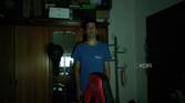 A man standing in a dark room in front of a wardrobe. The webcam has managed to track the user and keep him centered in the frame