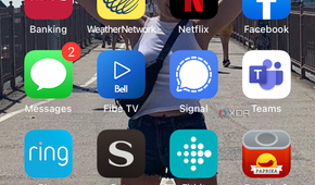 iPhone home screen with the Photos app selected.