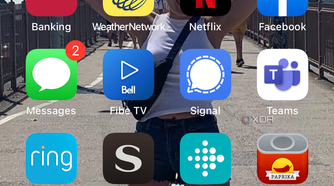 iPhone home screen with the Photos app selected.