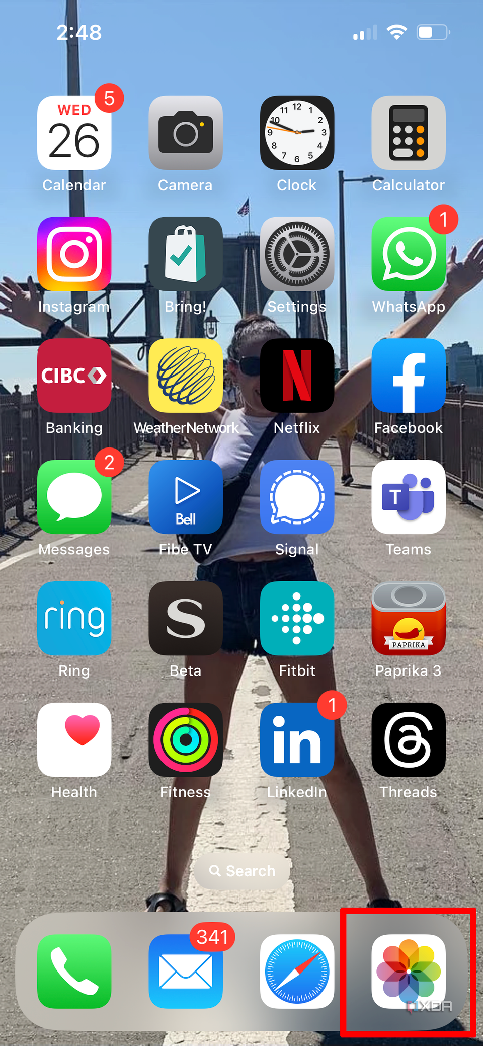 iPhone home screen with the Photos app selected.