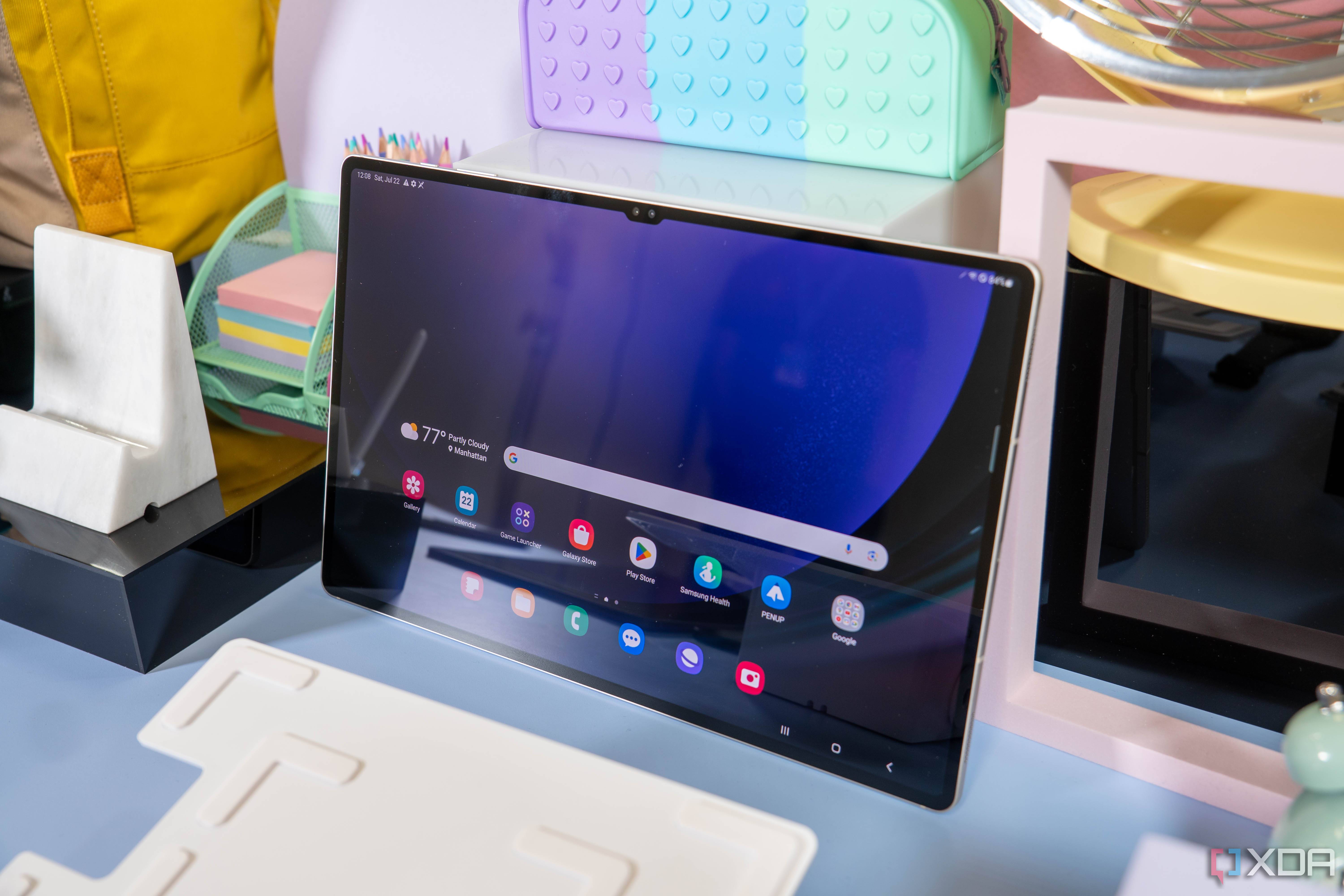 Samsung Galaxy Tab S9 Ultra propped up against a wall on a desk