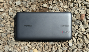UGreen's 145W Power Bank on gravel rocks.