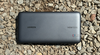 UGreen's 145W Power Bank on gravel rocks.