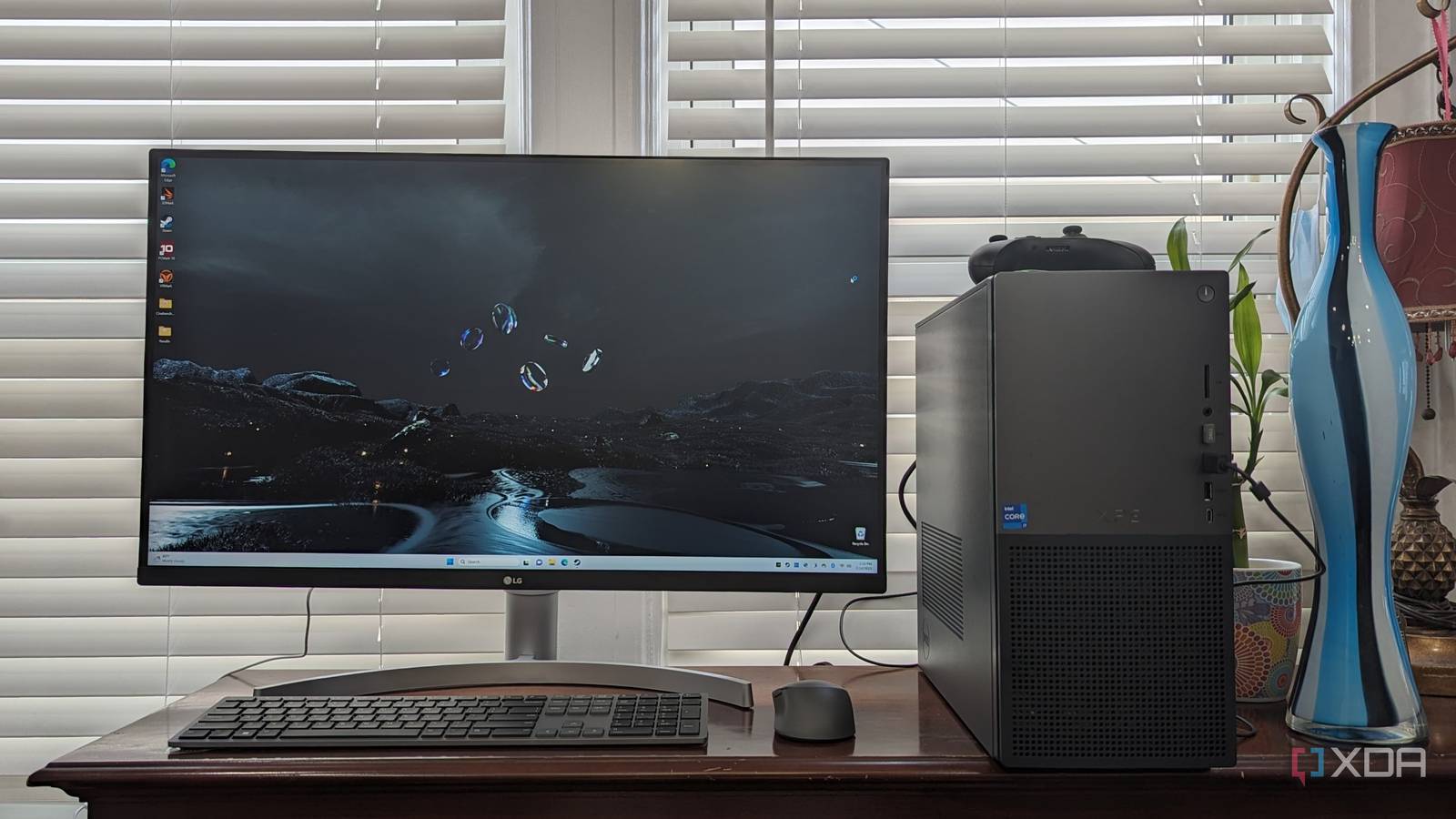 XPS Desktop 8960 sitting on a desk with vases and blinds in the back