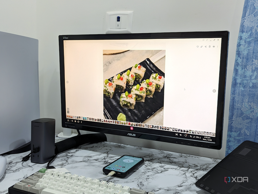Image in the gallery showing the DeX setup with a monitor showing a picture of a sushi bowl.