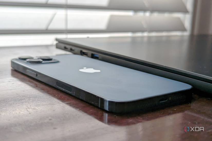 The side profile of the Acer Swift Edge 16 as it sits next to an iPhone