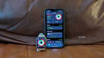 The Apple Fitness app on an iPhone 14 and Apple Watch propped up side by side.