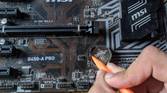 An image of a CMOS battery inside an MSI B450-A Pro motherboard