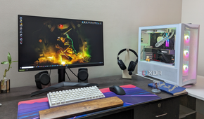 Desktop PC setup showing a gaming PC, monitor, keyboard, mouse, and headset